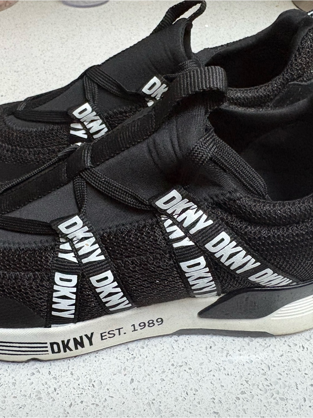DKNY Men’s Black and White Slip-On Logo Sneakers